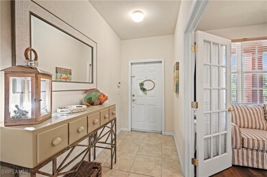 Entryway with baseboards, a textured ceiling, and