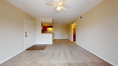 Empty room featuring a ceiling fan, visible vents,