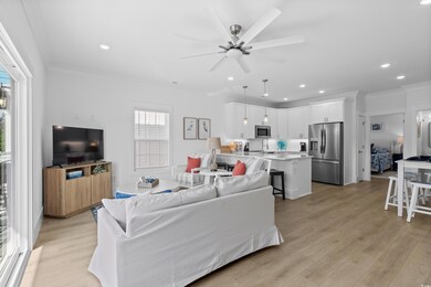 Living room featuring ornamental molding, light wood-type flooring, recessed lighting, and ceiling fan