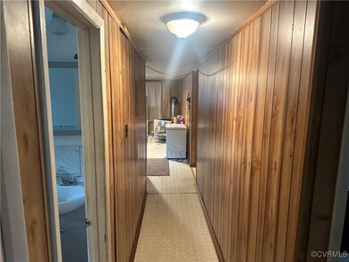 Hallway featuring wood walls and sink