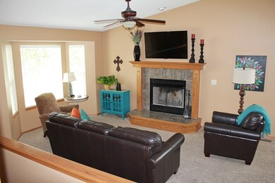 Living room has wood burning fireplace, open with 