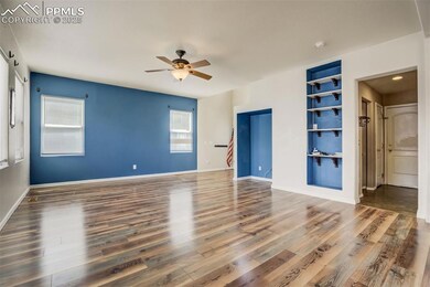Spare room featuring baseboards, wood finished flo