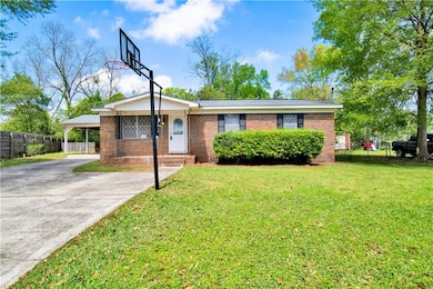 Ranch-style home featuring fence, concrete drivewa