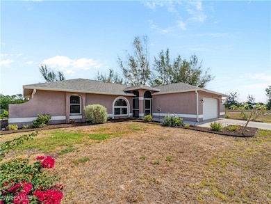 Ranch-style house featuring an attached garage, st