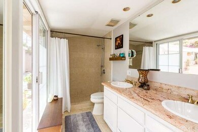 Master bath with dual sinks and granite counter to