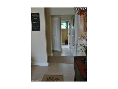 Ceramic tiled entryway.