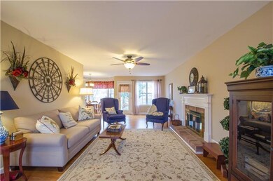 This large living room has beautiful floors and a brick fireplace. Lots of natural light.