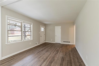 Spare room featuring dark hardwood / wood-style fl