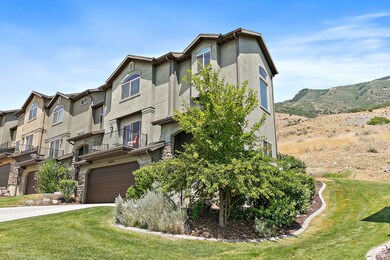 View of building exterior featuring driveway and an attached garage