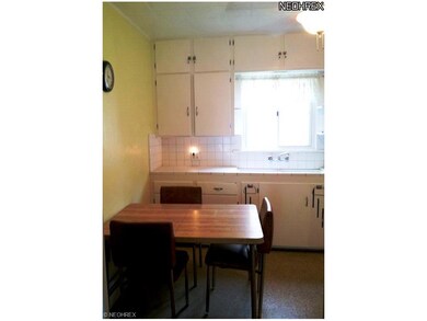 Eat in kitchen with refrigerator and stove.