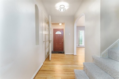 Looking at front door and stairs going up to 2 bedrooms