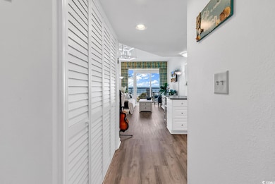 Hallway with wood finished floors and recessed lighting