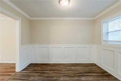 Spare room featuring crown molding, a textured cei