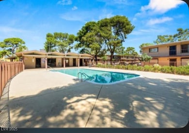 Pool featuring a patio and fence