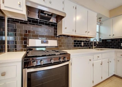 Kitchen featuring light tile patterned floors, st