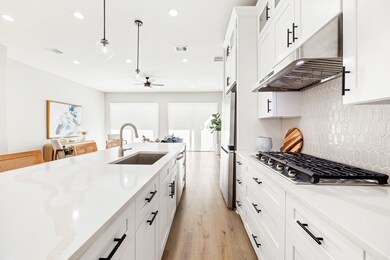 Floor to ceiling, soft-close cabinetry paired with matte black hardware.