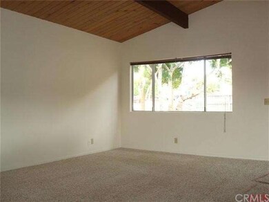 Spacious living room with vaulted wood ceilings.