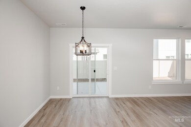 Unfurnished room with a chandelier and light wood-style floors