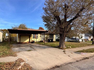 View of front of property featuring a carport, a g