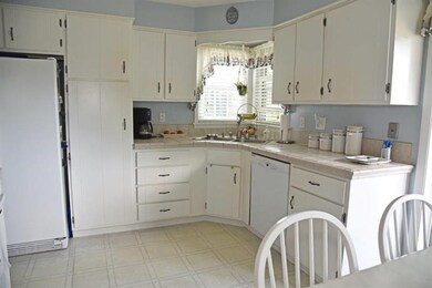 The kitchen has ample storage and tile counter spa