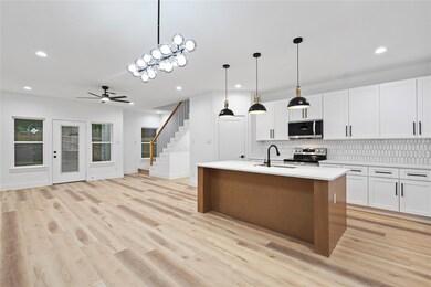 Kitchen featuring a ceiling fan, appliances with s