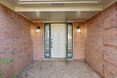 View of exterior entry with brick siding