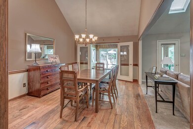 This Grand, Vaulted Dining space with Hardwood flo