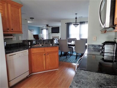 Kitchen has tall cabinets with crown molding and h