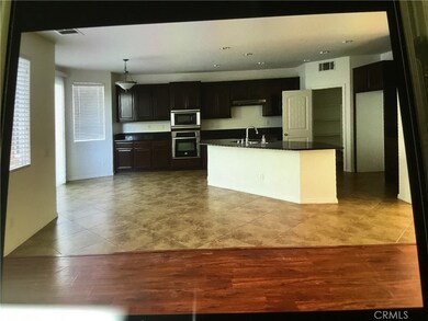 downstairs kitchen with walk-in pantry on the right side, left side to backyards patio.