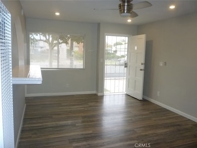 View of the front door as seen from the hallway leading to the two bedrooms and bathroom. The large kitchen is to the left.