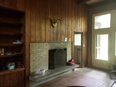 brick fireplace with solid paneling