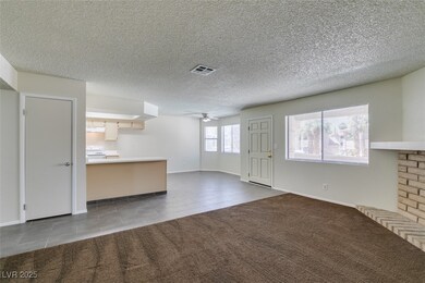 Unfurnished living room with a ceiling fan, tile p