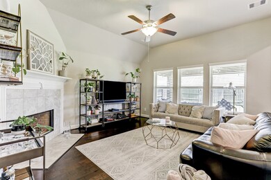 Gorgeous open feeling living room with beautiful mantle and windows overlooking the backyard