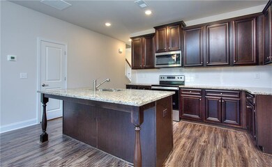 Kitchen with stainless steel appliances, sink, dec