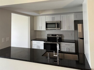 Kitchen featuring a sink, backsplash, white cabin