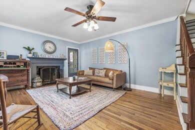 Living room featuring ceiling fan, hardwood / wood