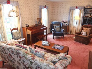 Living room has fireplace and arched doorways.