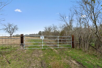 View of gate with a rural view and fence