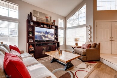Sunken formal living room with plenty of natural l
