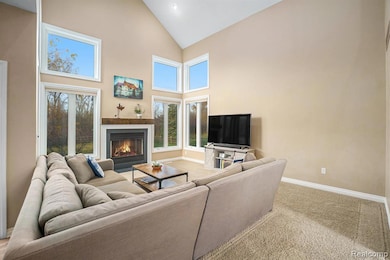 Living area with high vaulted ceiling and fireplace