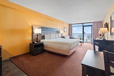 Bedroom featuring access to outside, a wall of win
