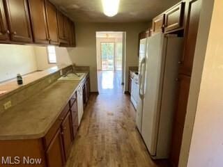 Kitchen with white refrigerator, light countertops