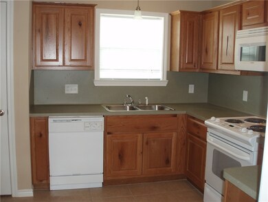 Kitchen featuring hanging light fixtures, sink, ti