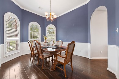 Gorgeous finishes and details complete the formal dining space 
 including chair rail, crown molding arched windows and plantation shutters.