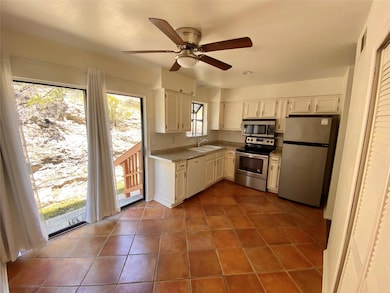 Kitchen with stainless steel appliances, a sink, 