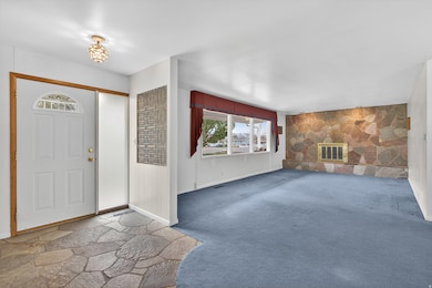 Foyer entrance with large family room and fireplace