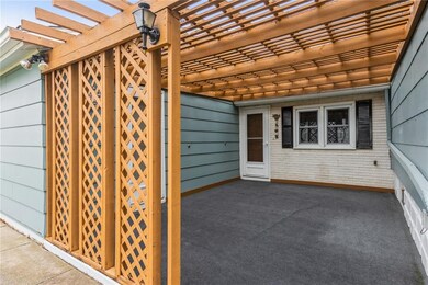 Adorable covered patio off the breezeway