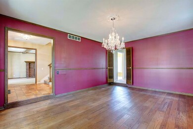 Rich colored walls, wood flooring and a beautiful 