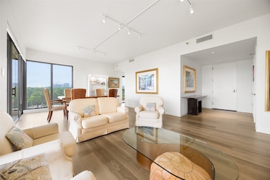 Living room surrounded by windows and access to the terrace