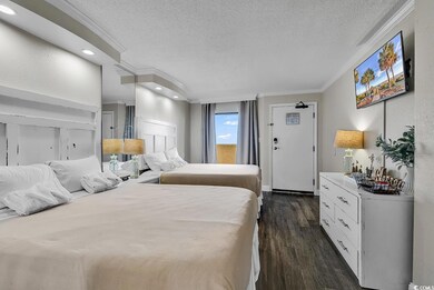 Bedroom with ornamental molding, a textured ceiling, dark wood-style floors, and recessed lighting